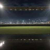 Gramado de futebol em Mirassol à noite, com bola junto à linha lateral, refletores e arquibancadas desfocadas.