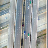 Vista aérea de rodovia movimentada em São Paulo, com carros e caminhões em várias faixas