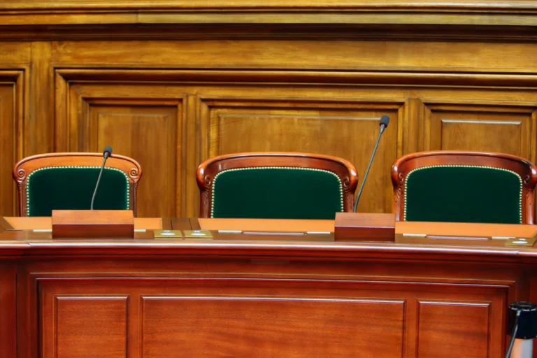 Bancada de madeira e cadeiras vazias em sala de reuniões